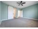 Bedroom featuring a barn door and access to hallway at 41333 N Belfair Way, Anthem, AZ 85086