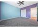 Spacious bedroom with two-tone walls, ceiling fan, and closet at 41333 N Belfair Way, Anthem, AZ 85086
