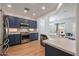 Open concept kitchen with island, stainless steel appliances, and breakfast bar at 41333 N Belfair Way, Anthem, AZ 85086