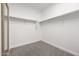 Spacious walk-in closet with hanging rods and mirror at 41333 N Belfair Way, Anthem, AZ 85086