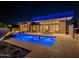 Luxury backyard at night with a pool and open floor plan at 37200 N Cave Creek Rd # 1005, Scottsdale, AZ 85262