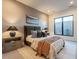 Guest bedroom with cozy bedding and window seat at 37200 N Cave Creek Rd # 1005, Scottsdale, AZ 85262