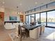 Open concept dining area with a wooden table, modern chairs and a view of the backyard pool at 37200 N Cave Creek Rd # 1005, Scottsdale, AZ 85262