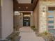 Private gated entry with modern metal gate and stone walls at 37200 N Cave Creek Rd # 1005, Scottsdale, AZ 85262