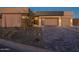 Stunning contemporary home with desert landscaping and a large paved driveway at 37200 N Cave Creek Rd # 1005, Scottsdale, AZ 85262