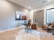 Bright home office with wood desk, rug, and comfortable chair at 37200 N Cave Creek Rd # 1005, Scottsdale, AZ 85262