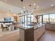 Open concept kitchen with a large island, stainless steel appliances, and views of the backyard at 37200 N Cave Creek Rd # 1005, Scottsdale, AZ 85262