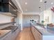 Modern kitchen featuring gas cooktop, custom cabinetry, and a large island with seating at 37200 N Cave Creek Rd # 1005, Scottsdale, AZ 85262