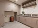 Laundry room with custom cabinetry and a built-in sink at 37200 N Cave Creek Rd # 1005, Scottsdale, AZ 85262