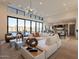 Spacious living room with sectional sofa, large windows, and views of the pool at 37200 N Cave Creek Rd # 1005, Scottsdale, AZ 85262