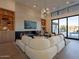 Open living space with sectional sofa, fireplace, and access to pool area at 37200 N Cave Creek Rd # 1005, Scottsdale, AZ 85262