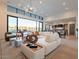 Spacious living room with sectional sofa, large windows, and views of the pool at 37200 N Cave Creek Rd # 1005, Scottsdale, AZ 85262