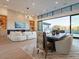 Open living and dining area with large windows and modern chandelier at 37200 N Cave Creek Rd # 1005, Scottsdale, AZ 85262