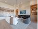 Modern living room features a white sofa, built-in shelving, fireplace, and large TV at 37200 N Cave Creek Rd # 1005, Scottsdale, AZ 85262