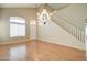 Dining room with hardwood floors, chandelier, and staircase at 7216 W Irma Ln, Glendale, AZ 85308