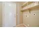 Laundry room with built-in shelving and hookups for washer and dryer at 7216 W Irma Ln, Glendale, AZ 85308
