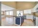 Open concept kitchen with island, stainless steel appliances, and white cabinets at 7216 W Irma Ln, Glendale, AZ 85308