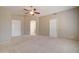 Bright bedroom featuring a ceiling fan and ample closet space at 7216 W Irma Ln, Glendale, AZ 85308