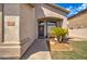 Front porch with a purple door, wreath, bench, and potted plant at 7216 W Irma Ln, Glendale, AZ 85308