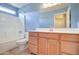 Clean bathroom with light blue walls, wood vanity, and a bathtub at 7216 W Irma Ln, Glendale, AZ 85308
