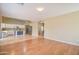 Open living room with hardwood floors and kitchen views at 7216 W Irma Ln, Glendale, AZ 85308