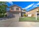 Two-story house with a gray garage door and well-maintained lawn at 7216 W Irma Ln, Glendale, AZ 85308
