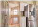 Kitchen with stainless steel refrigerator and wood pantry door at 7216 W Irma Ln, Glendale, AZ 85308