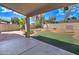 Covered patio overlooking a landscaped backyard with artificial turf at 7216 W Irma Ln, Glendale, AZ 85308