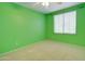 Green-walled bedroom with ceiling fan and window blinds at 7216 W Irma Ln, Glendale, AZ 85308