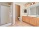 Bathroom boasts double sinks, shower, and updated light fixtures at 7216 W Irma Ln, Glendale, AZ 85308