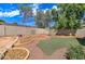 Landscaped backyard with artificial turf and stone accents at 7216 W Irma Ln, Glendale, AZ 85308