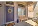 Front entryway with a purple door, wreath, and welcome mat at 7216 W Irma Ln, Glendale, AZ 85308