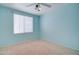 Bedroom with light blue walls, ceiling fan and window blinds at 7216 W Irma Ln, Glendale, AZ 85308