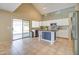 Kitchen with island, white cabinets, and backyard access at 7216 W Irma Ln, Glendale, AZ 85308