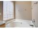 Bathroom features a corner soaking tub and a large window at 7216 W Irma Ln, Glendale, AZ 85308