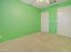 Light green bedroom with ceiling fan and double closets at 7216 W Irma Ln, Glendale, AZ 85308
