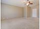 Spacious bedroom with ceiling fan and neutral carpeting at 7216 W Irma Ln, Glendale, AZ 85308