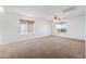 Bright bedroom with two windows and ceiling fan at 31777 N Sundown Dr, San Tan Valley, AZ 85143