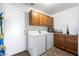 Laundry room with washer, dryer, and cabinets at 31777 N Sundown Dr, San Tan Valley, AZ 85143