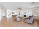 Spacious living room with light walls, wood-look floors, and a fireplace at 31777 N Sundown Dr, San Tan Valley, AZ 85143