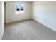 Spacious bedroom with neutral carpeting and large window at 4847 W Granada Rd, Phoenix, AZ 85035