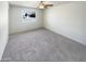 Bright living room with ceiling fan and neutral carpeting at 4847 W Granada Rd, Phoenix, AZ 85035