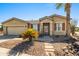 Tan one-story house with red shutters and a nicely landscaped yard at 42609 W Milky Way, Maricopa, AZ 85138