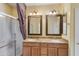 Double vanity bathroom with a large mirror and shower at 42609 W Milky Way, Maricopa, AZ 85138