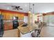 Open kitchen with granite island and stainless steel appliances at 42609 W Milky Way, Maricopa, AZ 85138