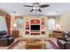 Living room with built-in shelving and a large TV at 42609 W Milky Way, Maricopa, AZ 85138