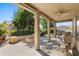 Covered patio with seating area and fire pit at 42609 W Milky Way, Maricopa, AZ 85138