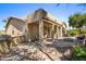 Home exterior showcasing patio, fire pit, and landscaping at 42609 W Milky Way, Maricopa, AZ 85138