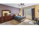 Bright bedroom with a double bed, dresser, and home office space at 42609 W Milky Way, Maricopa, AZ 85138