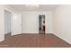 Bedroom with wood-look flooring and access to bathroom at 11308 W Hazelwood St, Phoenix, AZ 85037